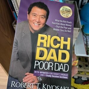 Rich Dad Poor Dad by Robert T. Kiyosaki - Purple & Yellow Cover